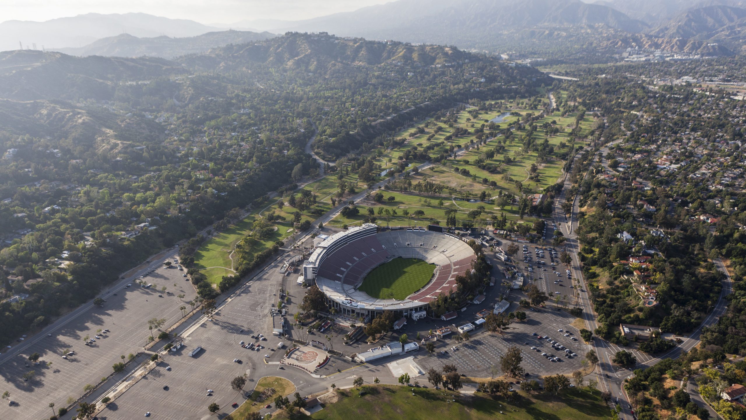 Overview of the historic Rose Bowl Stadium, along with surrounding parking and mountains
