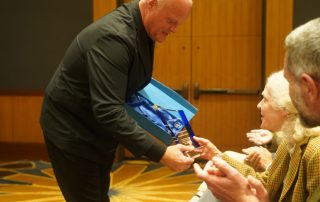 Pat Shoup is presented with the European Parking Award for Excellence in memory of Donald Shoup.