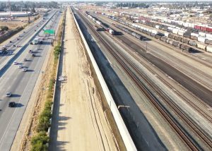 Aerial shot of Fresno with lanes from state Route 99 on the left and railroad tracks on the right.