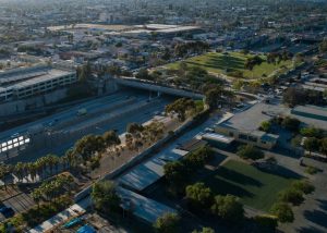Aerial image of Teralta Park, a freeway cap park above the 15 freeway, surrounded by homes and businesses in the adjacent neighborhood.
